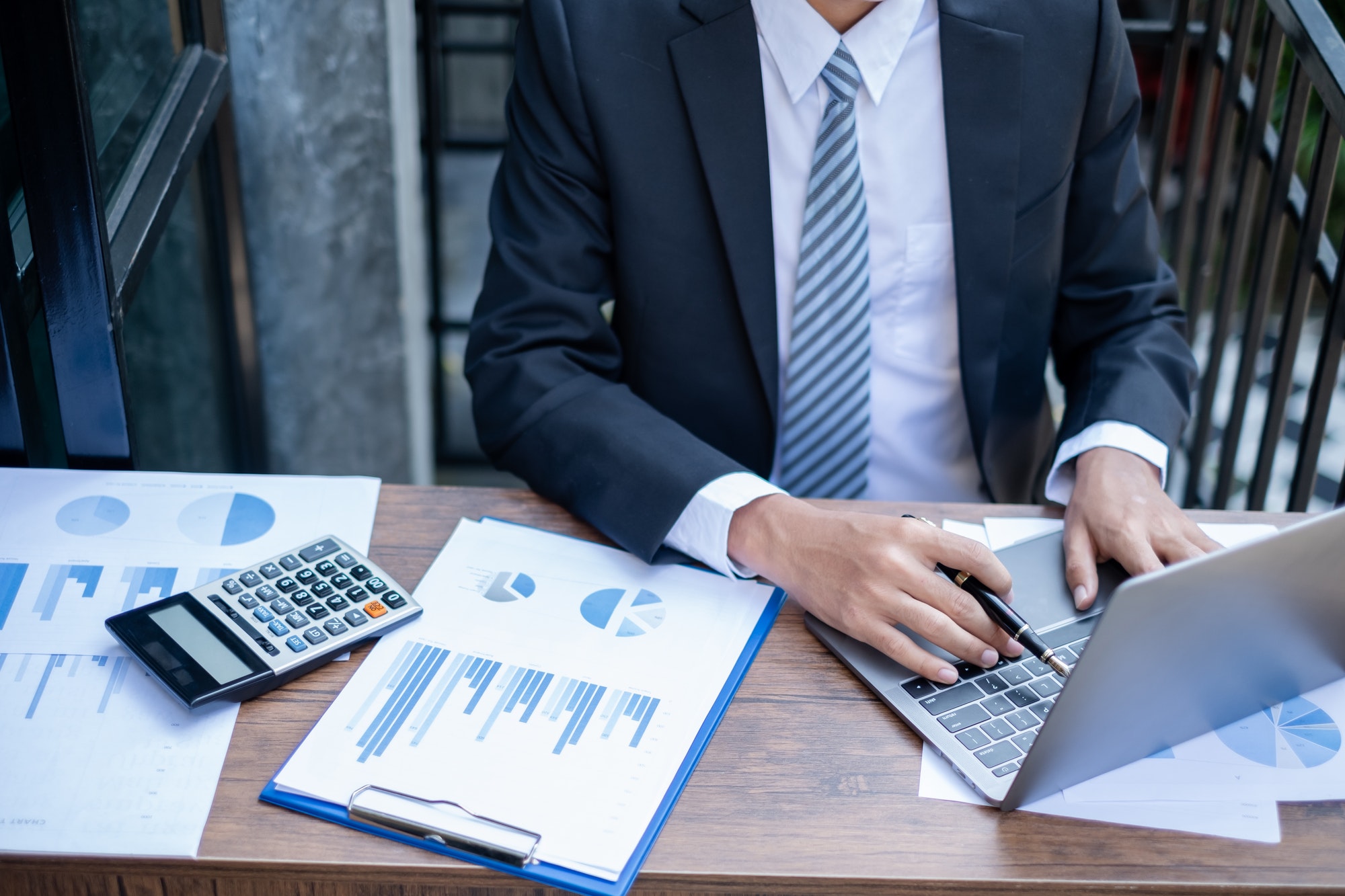 Young businessman financial market analyst sits at their desks and calculate financial